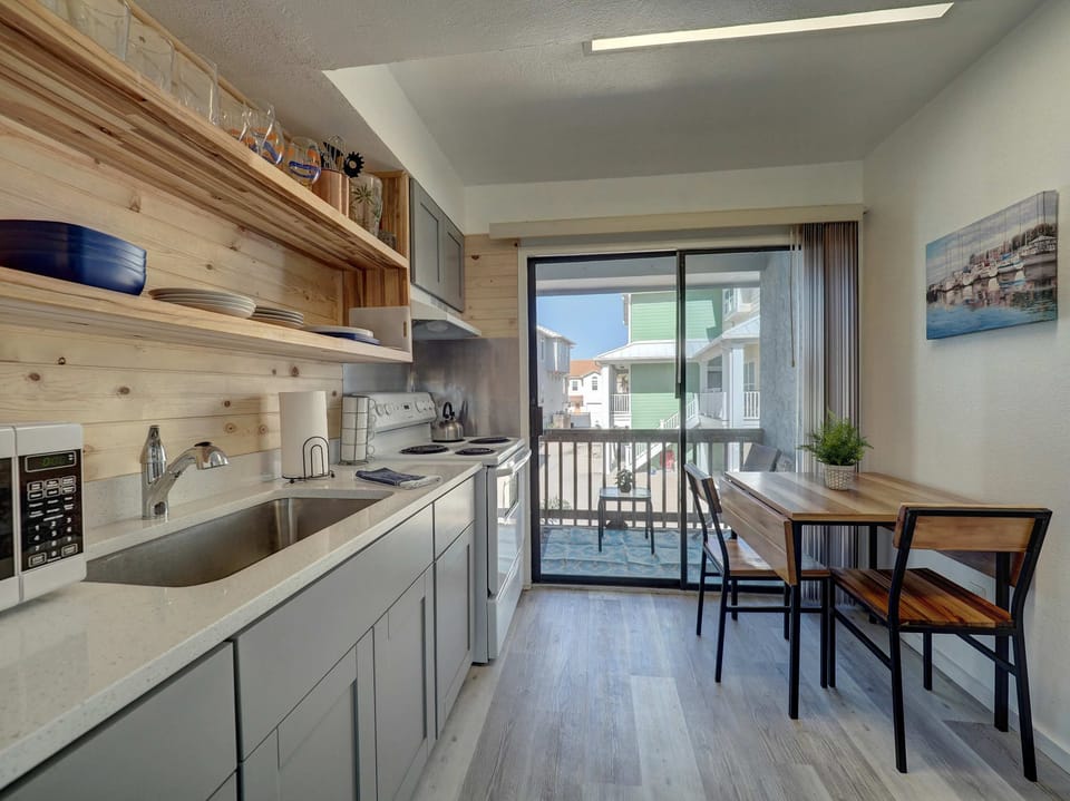 Prepare meals and enjoy them right at the cozy dining table beside it—a perfect setup for togetherness.