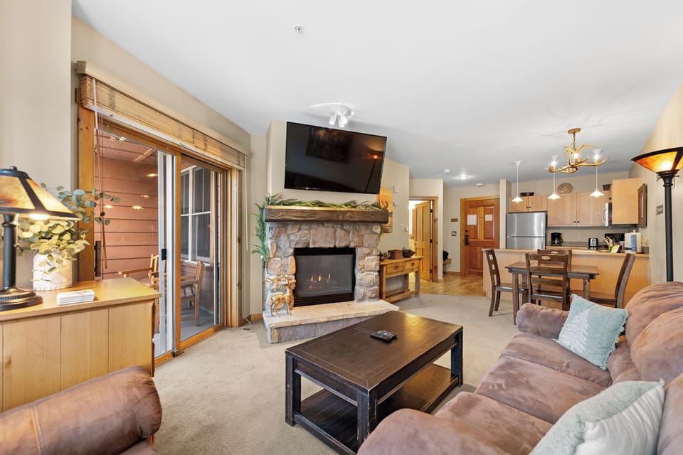Sink into plush seating by your crackling fireplace, with mountain views and open kitchen perfect for cozy evenings.