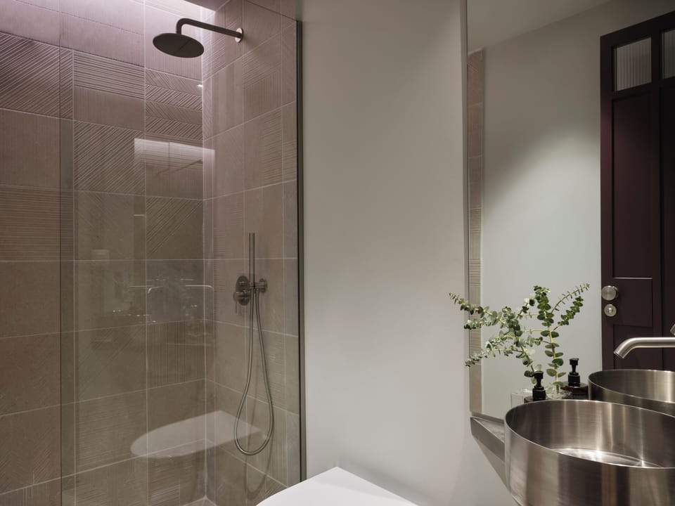 Deluxe Suite Semi-Basement | Bathroom | Shower, towels, soap, shampoo