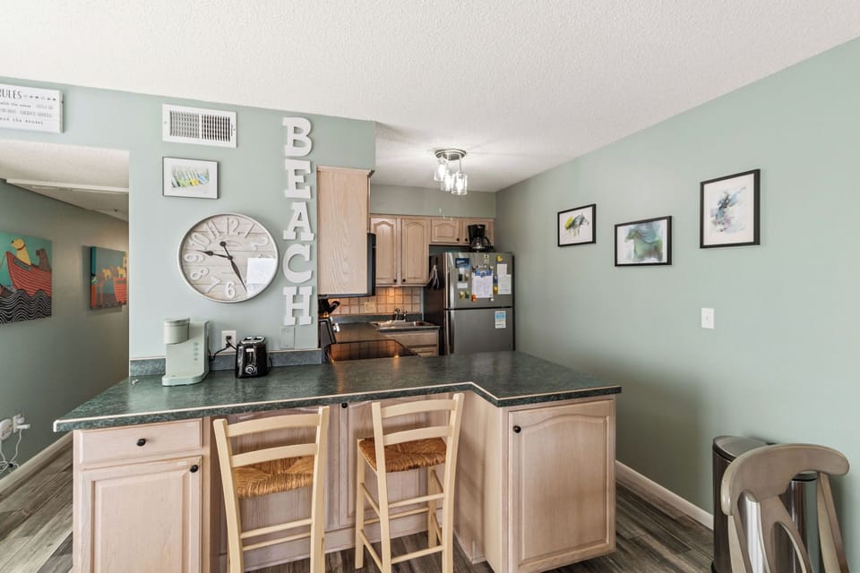 Kitchen - Black and stainless appliances, tons of counter space and a view this kitchen is sure to delight any cook.