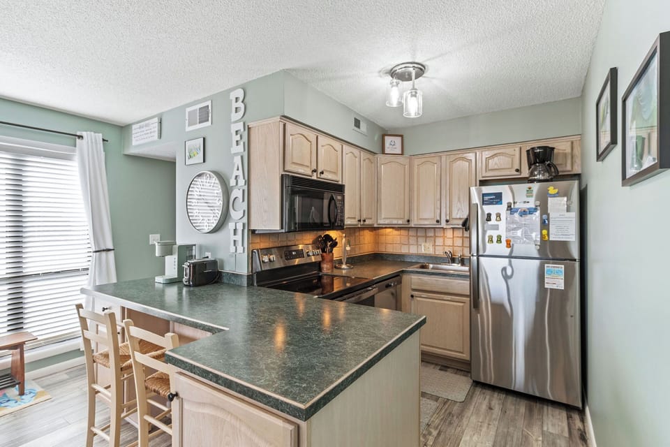 Kitchen - Black and stainless appliances, tons of counter space and a view this kitchen is sure to delight any cook.