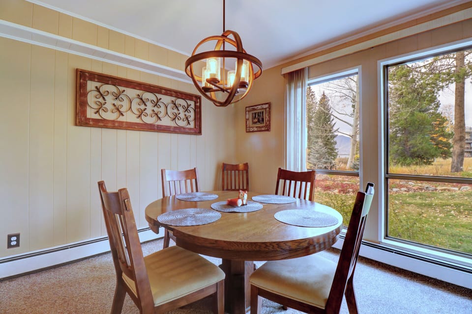 Nice dining room with large windows offering great views and ample natural light to come in.