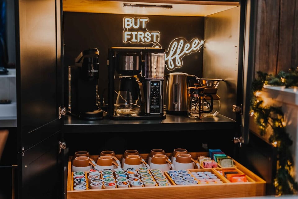 a fully stocked coffee bar featuring an assortment of teas, coffee and more.