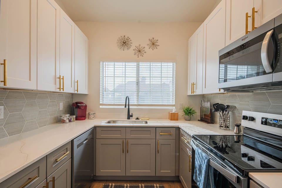 Modern kitchen with stylish gold accents.