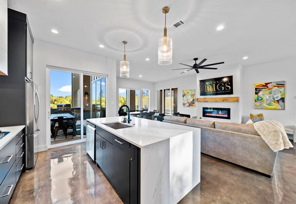 This bright and airy dining space invites everyone to gather for meals, games, and memories, all with beautiful views around.