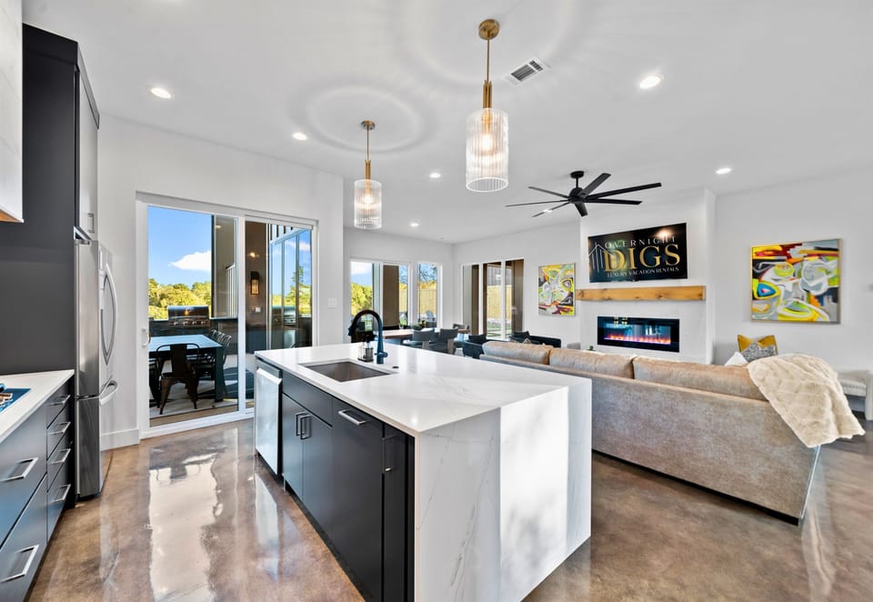 This bright and airy dining space invites everyone to gather for meals, games, and memories, all with beautiful views around.