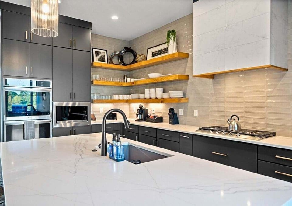 Everything you need is within reach in this organized kitchen. From snacks to drinks, it's designed for convenience and enjoyment.