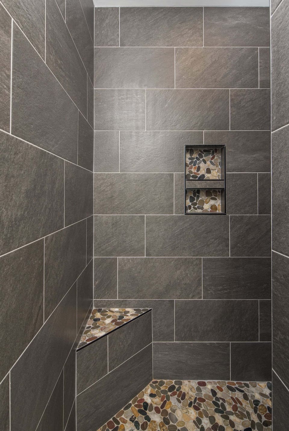 Tiled walk-in shower in the primary ensuite bathroom