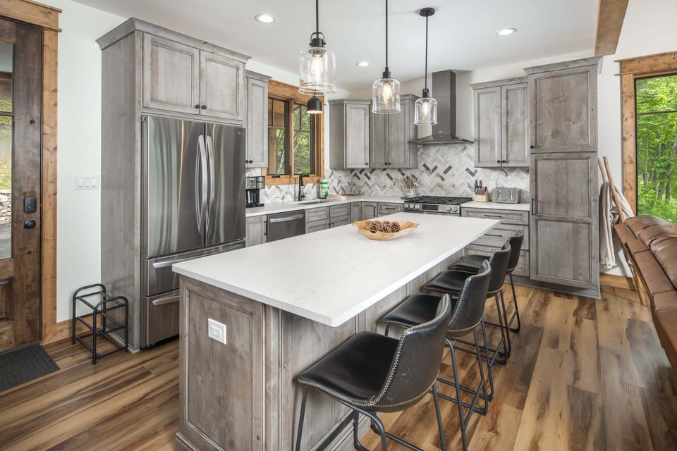 Gourmet kitchen with large island seating and stainless steel appliances