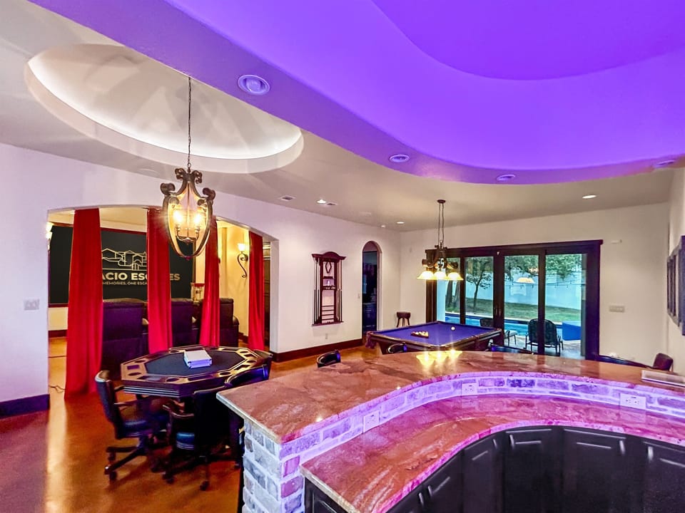 Where fun meets style – the ultimate adult game room, complete with a bar, pool table, poker table, and media room for endless entertainment.