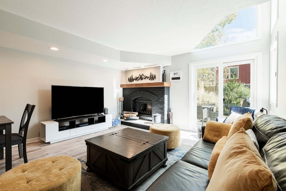 Living Room with TV, fireplace, yellow accents, and flooded with natural light