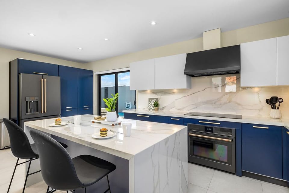 Cook up a feast in the fully equipped kitchen featuring high-end appliances, a central island, and all the essentials for creating delicious meals for your group