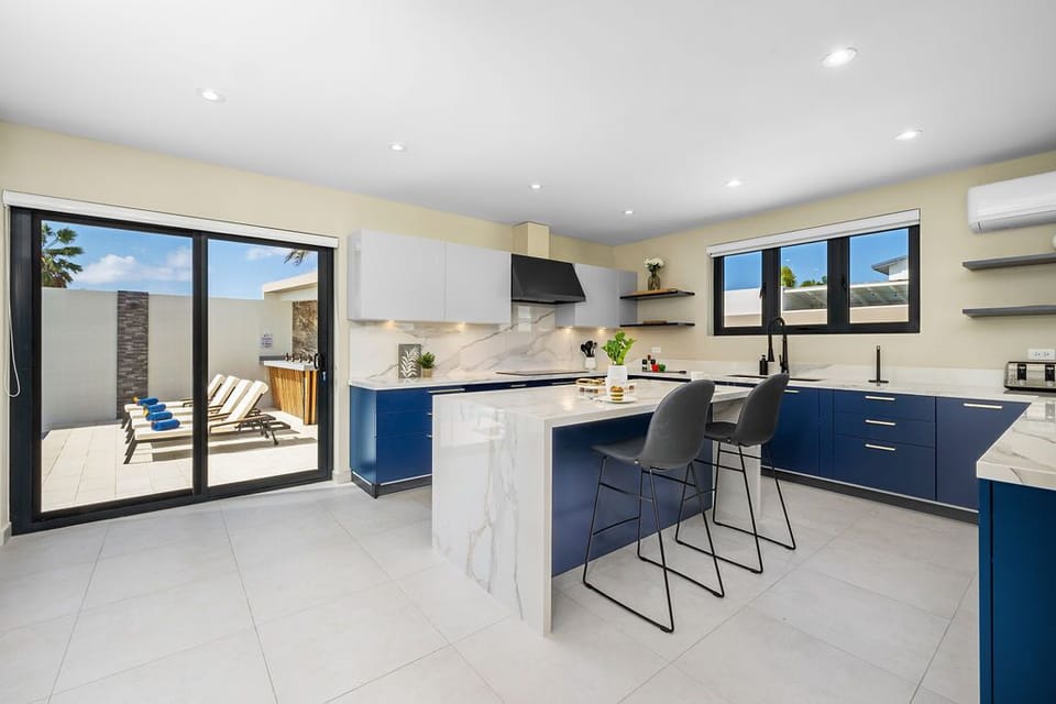 Cook up a feast in the fully equipped kitchen featuring high-end appliances, a central island, and all the essentials for creating delicious meals for your group