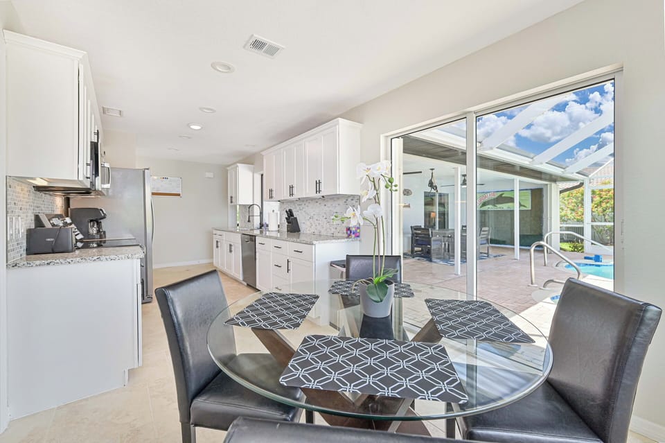 DINING AREA HAS FULL VIEW OF POOL AREA AND WATERFRONT