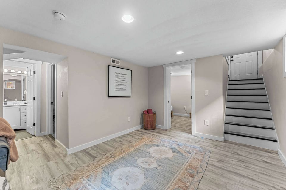 Basement Living Room: Spacious and bright, perfect for gatherings or relaxing after Denver adventures. 3rd bedroom, 2nd office space and full bathroom.