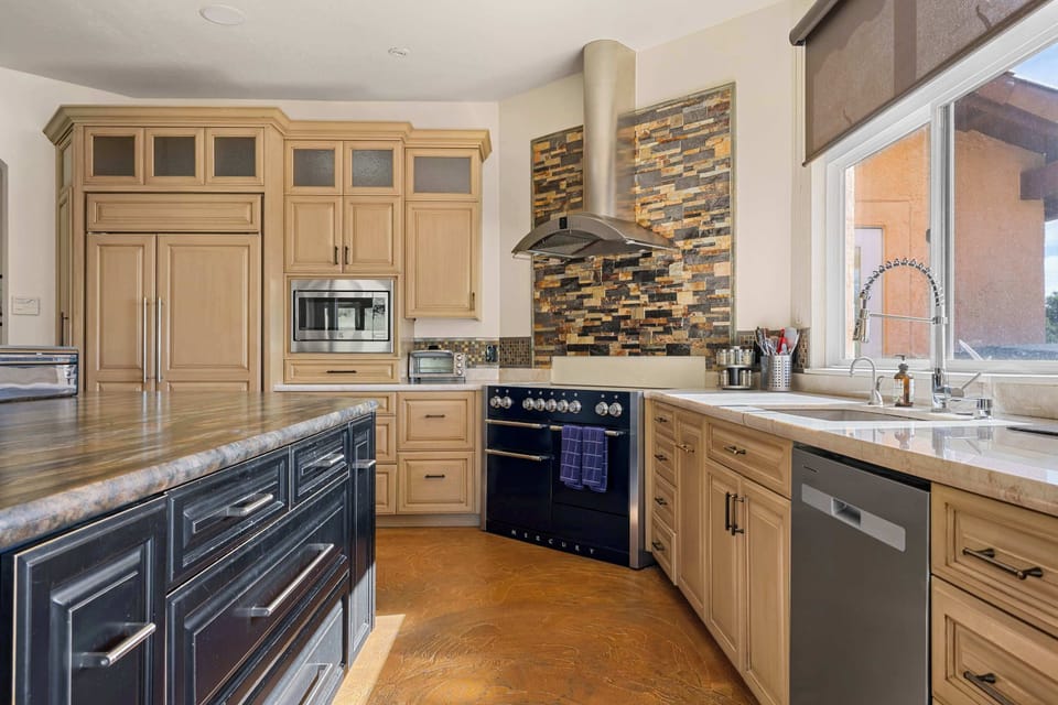 Sub-Zero appliances, 8-burner induction stove, custom cabinetry, and a breakfast nook with vineyard views — this kitchen is built for serious cooking and casual mornings equally