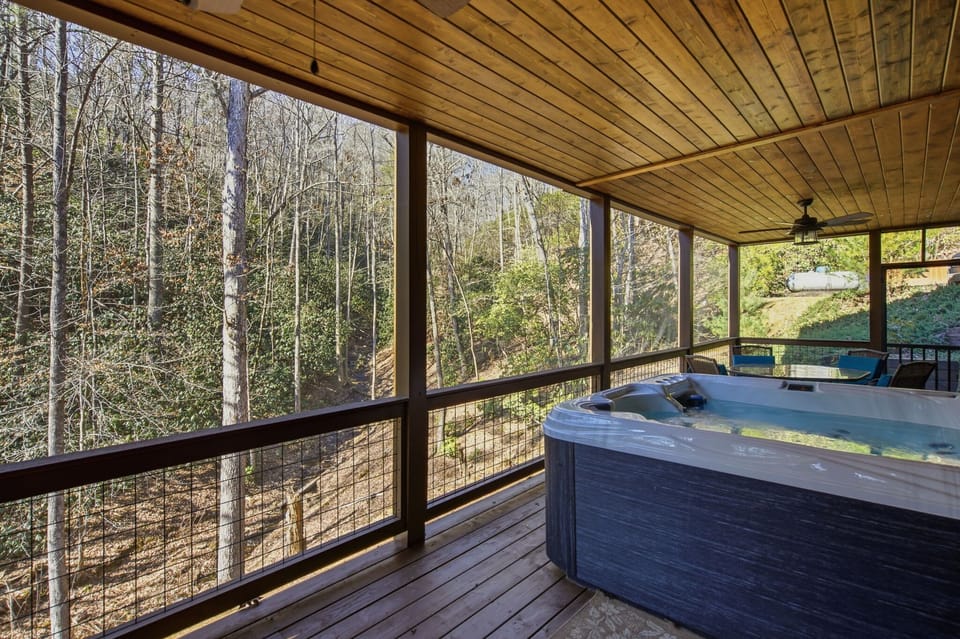Soak away the stress with views of the running creek and private waterfall next to the woods