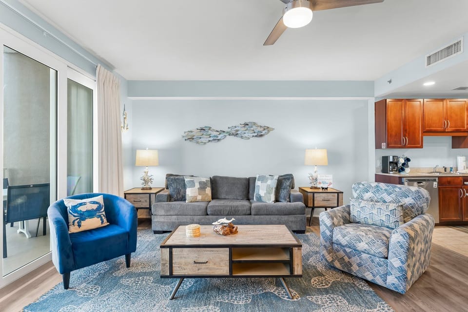 Relax in this modern living room featuring comfortable seating and soft blue accents.