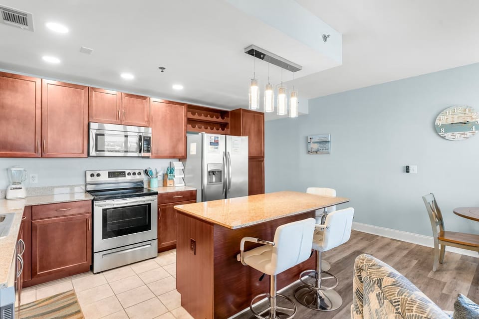 Modern kitchen with stainless steel appliances and a central island for casual dining