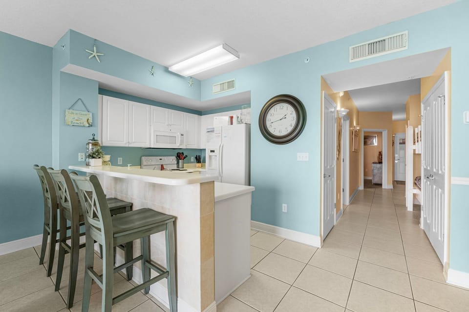 Light-filled kitchen with a breakfast bar and coastal-inspired decor.