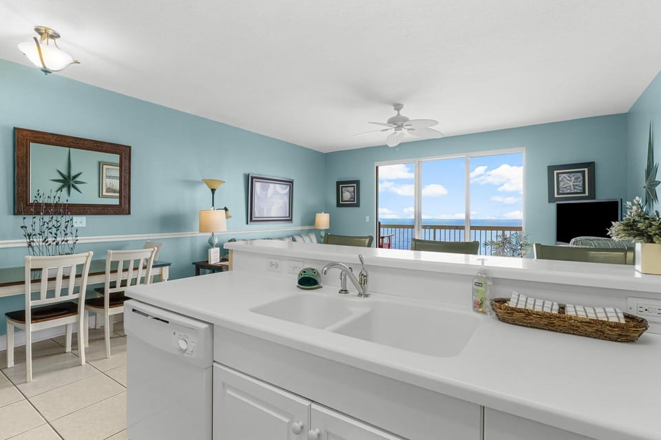 Open kitchen with ocean views and a light blue coastal design.