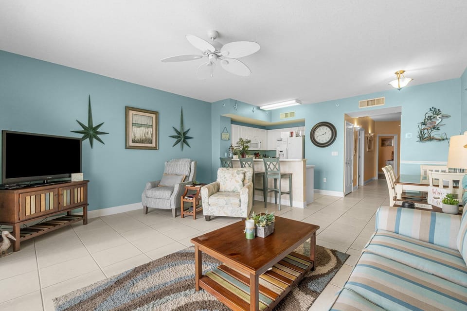 Relax in this cozy living room with soft blue walls and comfortable seating.