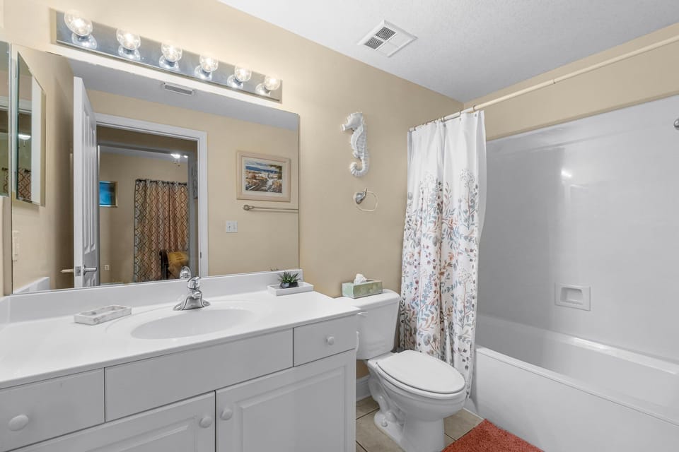 Clean bathroom with a bathtub and shower combination