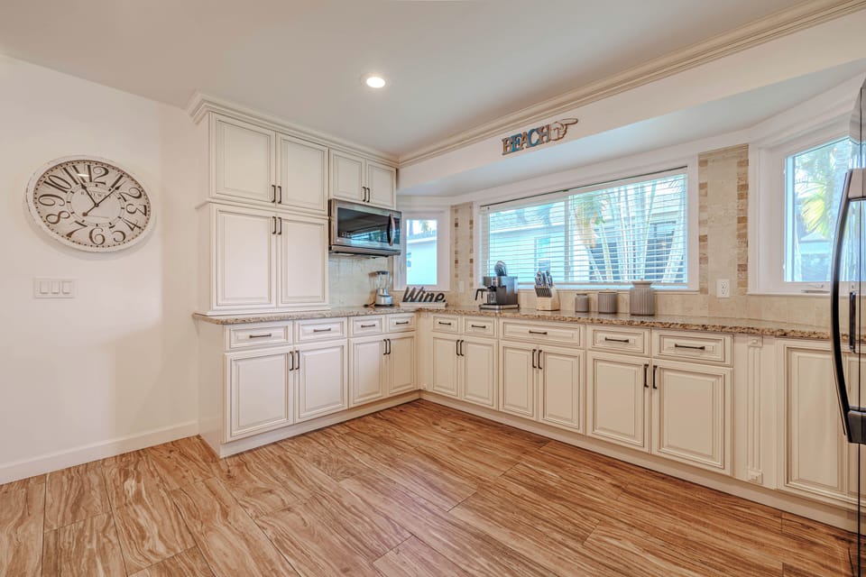 - Bright and airy kitchen offers plenty of space to cook and create
- Stylish cabinetry, modern appliances, and a charming window view make it feel like home
- Whether you're whipping up a feast or enjoying coffee, this space is designed for you