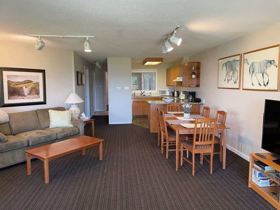 Living room and dining table for six.  Kitchen is at back