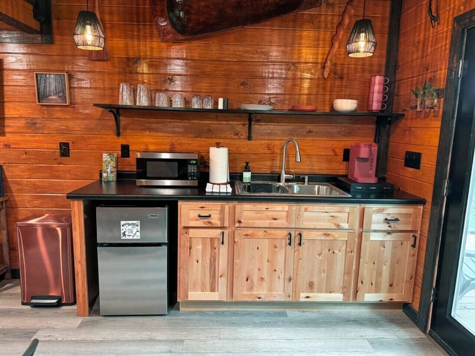 Well-equipped kitchenette with a mini fridge, microwave, coffee maker, and sink