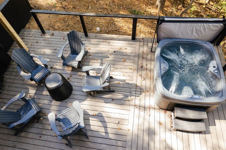 Spacious outdoor deck with a private hot tub and Adirondack seating for relaxing evenings