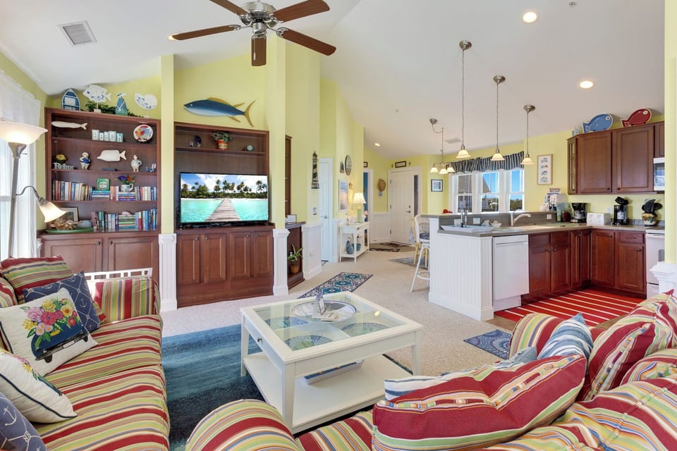 Step into the bright and open Living Area, where a pub table invites you to enjoy casual meals or evening cocktails with stunning water views.