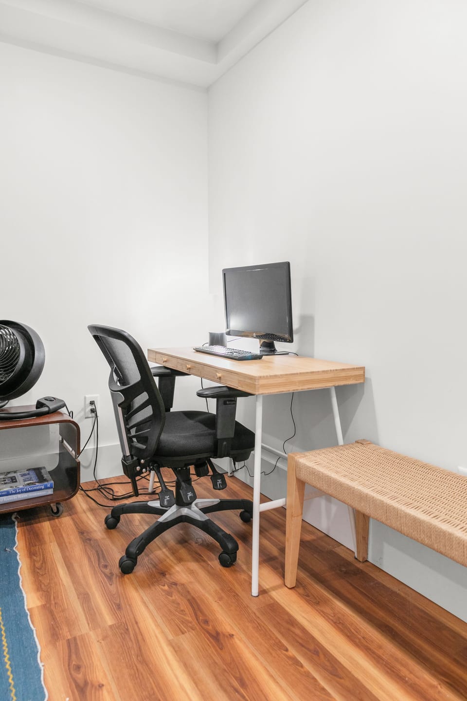 This efficient workspace features a sturdy table and an ergonomic office chair.