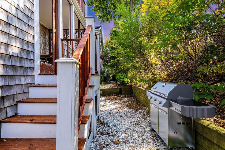Steps lead down to a grilling area, perfect for outdoor dining and entertaining.