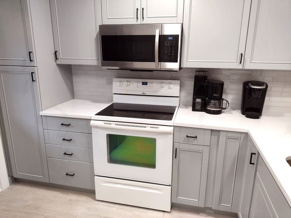 Fully equipped kitchen with modern appliances and a spacious breakfast bar with seating—perfect for cooking, dining, and gathering at Hilton Head Hideaway.