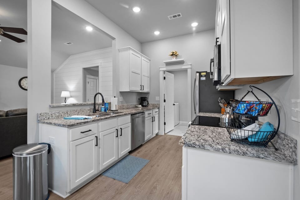 Pass through kitchen to laundry room & back door to patio. 