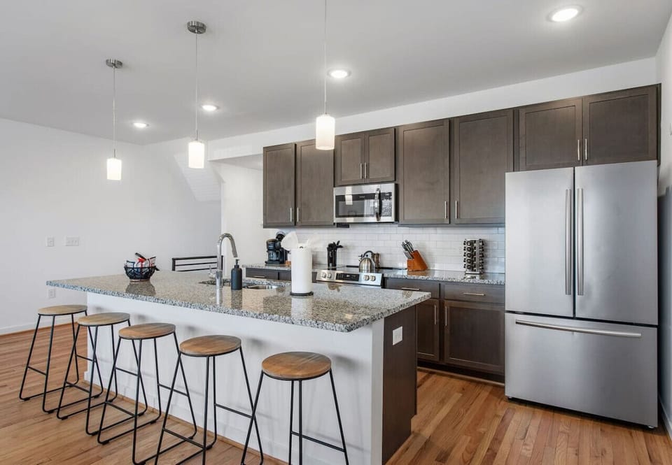 Cook, chat, and sip in this bright, fully stocked kitchen! With a spacious island and barstool seating, plus a Keurig to kickstart your mornings.