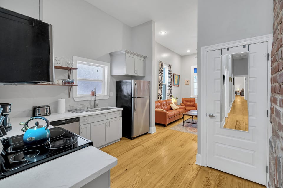Seamlessly connect from the kitchen to the cozy living area in this thoughtfully designed space. Perfect for socializing or relaxing after a day of exploring New Orleans!