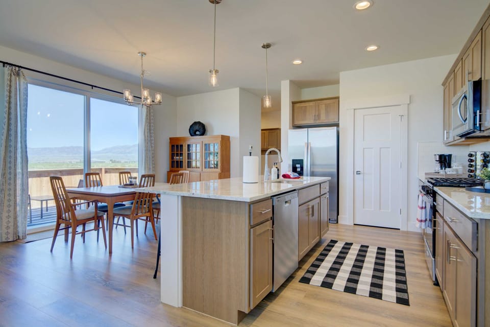 Dining Room: The dining area features large windows offering a picturesque view, enhancing the dining experience.