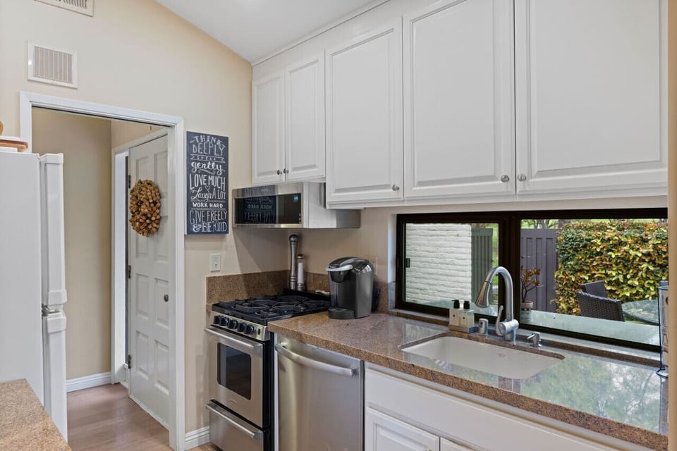The kitchen boasts warm details and a window that brings in lovely natural light.