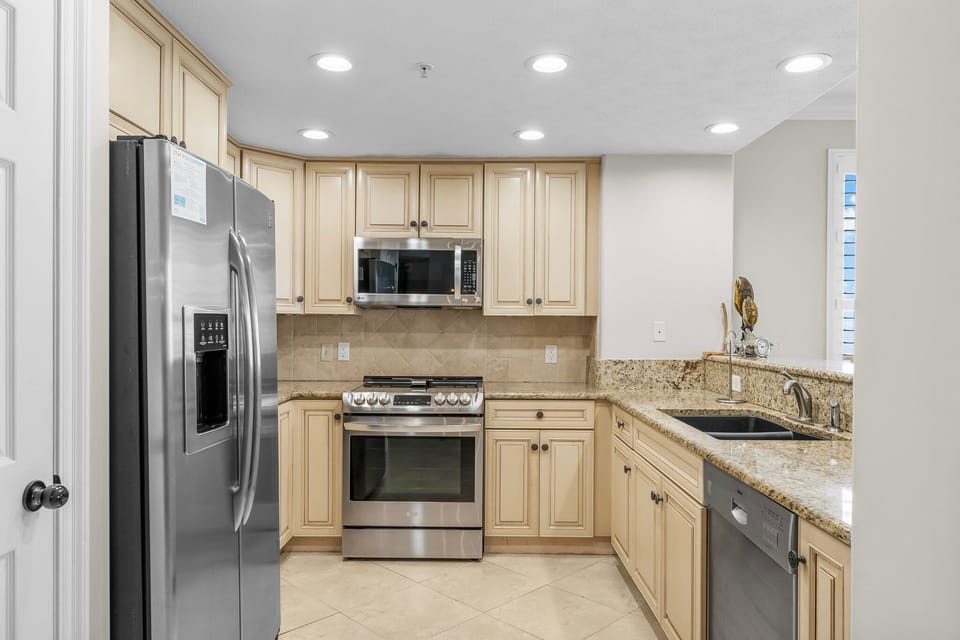 Modern kitchen with stainless steel appliances and granite countertops