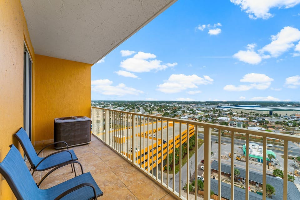 Relax on the balcony with expansive city views and comfortable seating.