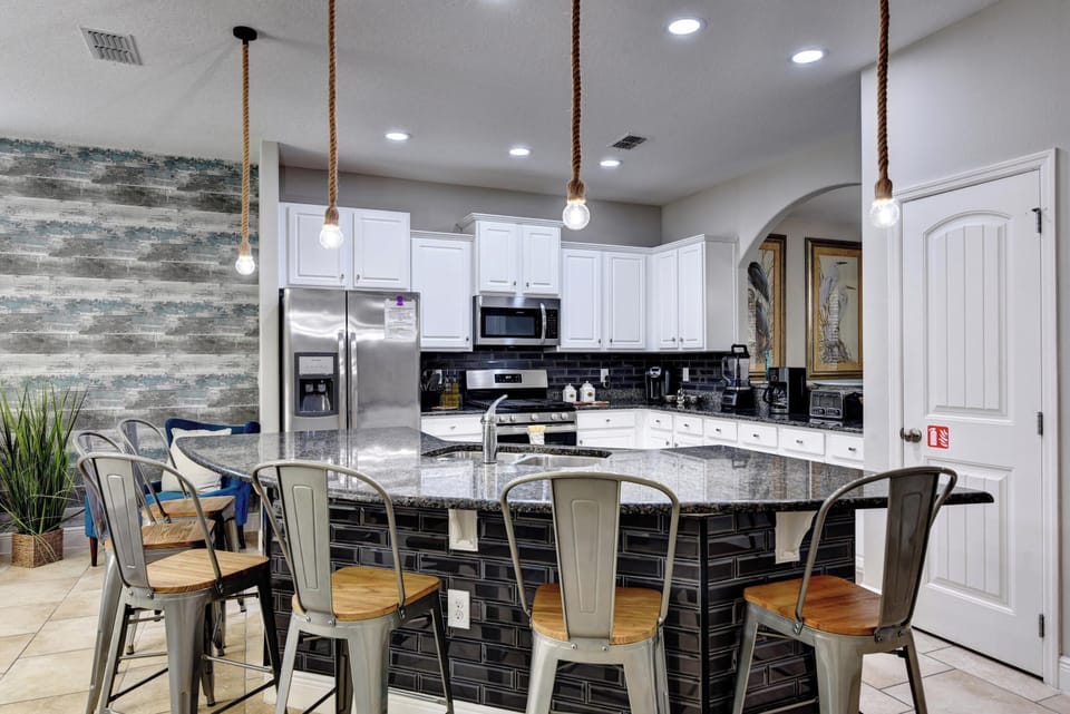 KITCHEN:  Fully Equipped Kitchen with Seating for 6 at Kitchen Island, Refrigerator, Microwave, Stove and Dishwasher