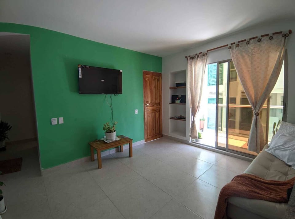 Deluxe Suite, Balcony, Beach View | Living area | 43-inch TV with digital channels