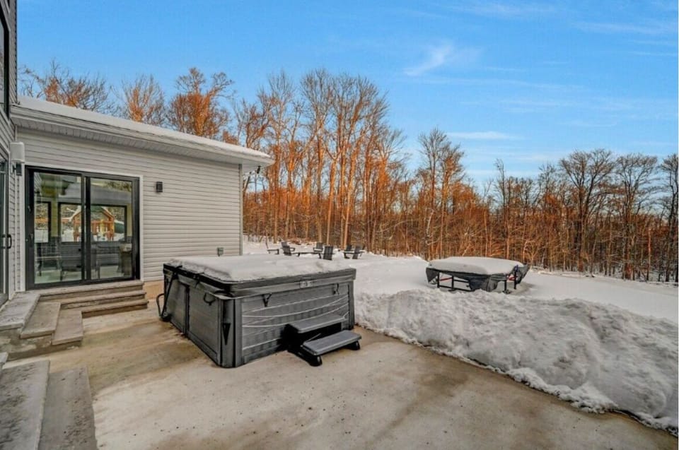 Outdoor hot tub with snowy views, perfect for relaxing in any season.