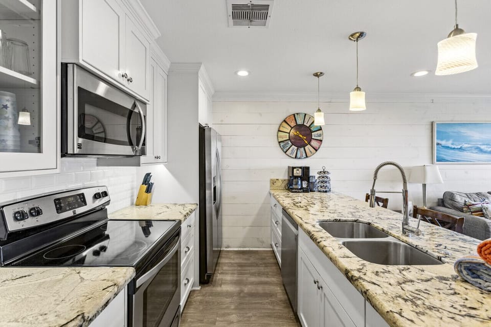 Fully equipped kitchen with granite countertops and modern appliances