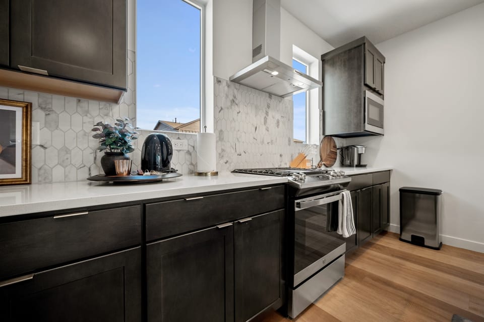 This well-equipped kitchen features a gas stove, dishwasher, microwave, and other appliances for your convenience and culinary enjoyment.