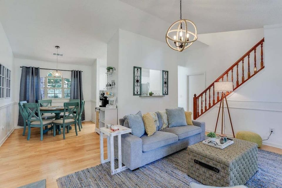 The open-concept design at seamlessly connects the living room to the dining area, creating a spacious and inviting environment perfect for family gatherings and entertaining.