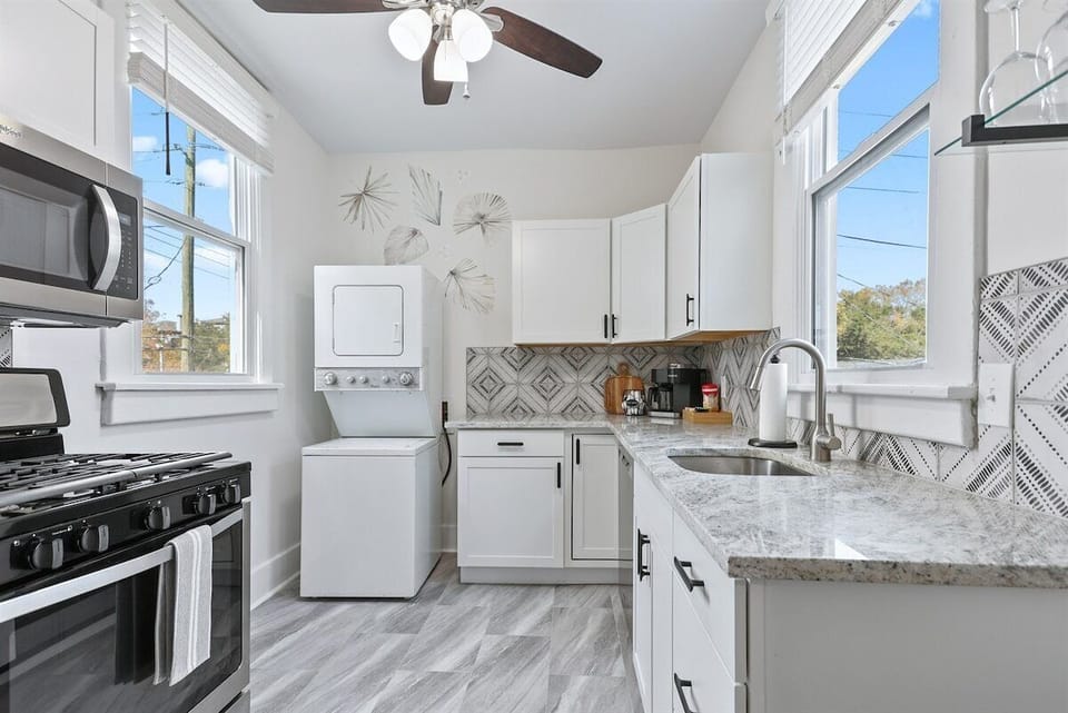 The fully equipped kitchen features a gas range and sleek stainless steel appliances, ready for creating delicious meals and memorable moments.