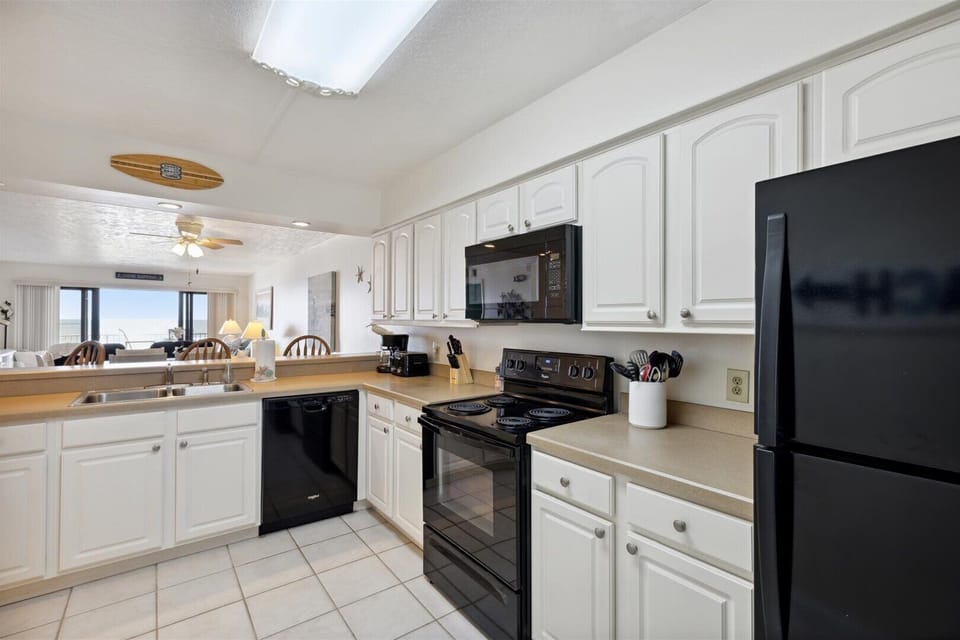 Spacious kitchen with modern appliances and a view of the dining and living areas.